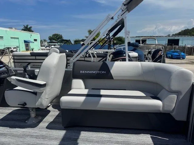 Slide: The Image of 2026 Bennington 20SSRSE pontoon boat with gray seating outdoors. - 28