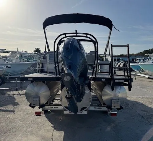 Slide: The Image of Rear view of a 2026 Sweetwater 2286SFLC pontoon boat at the dock. - 24