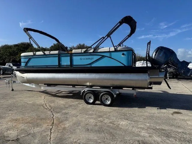 Slide: The Image of 2026 Sweetwater 2286CP pontoon boat on trailer, blue sky. - 22