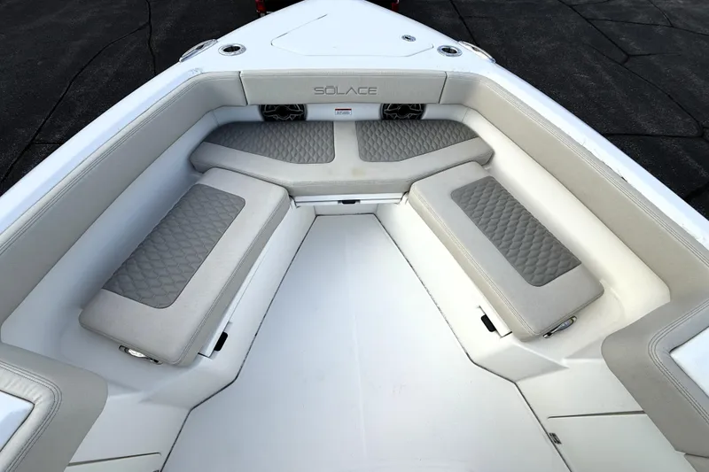 Slide: The Image of 2023 Solace 30 HCS boat interior with cushioned seating and modern design. - 10