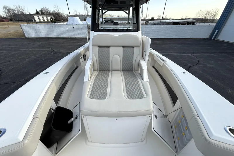Slide: The Image of 2023 Solace 30 HCS boat interior with cushioned seating and storage compartments. - 13