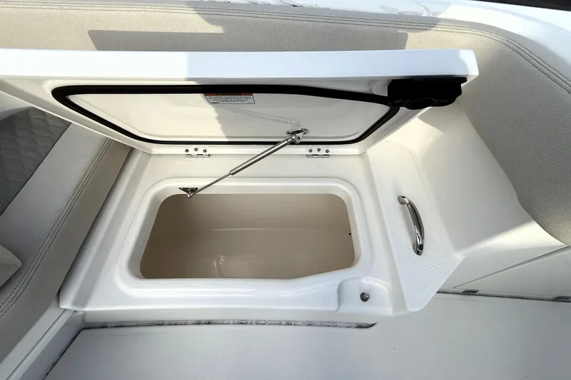 Slide: The Image of Open storage compartment on 2023 Solace 30 HCS boat, featuring sleek design and sturdy handle. - 14