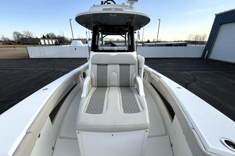 Slide: The Image of 2023 Solace 30 HCS boat interior with cushioned seating and modern design. - 16