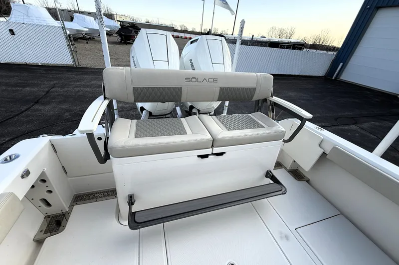 Slide: The Image of 2023 Solace 30 HCS boat with dual outboard engines and cushioned seating. - 17