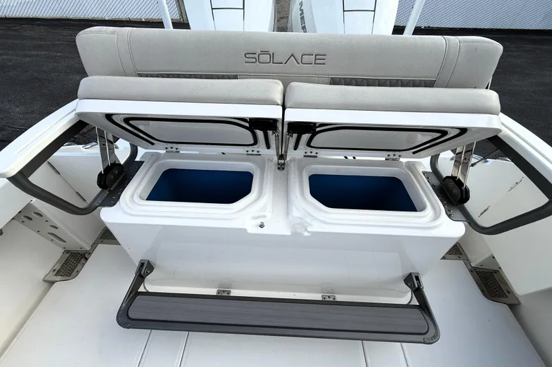 Slide: The Image of 2023 Solace 30 HCS boat with open storage compartments and cushioned seating. - 20