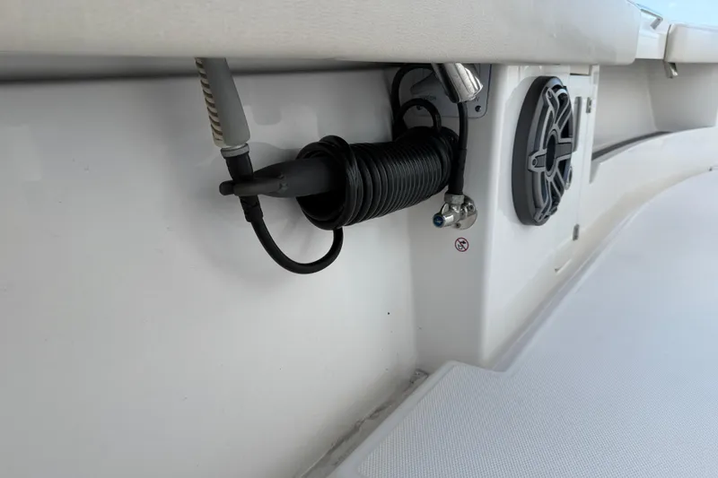 Slide: The Image of 2023 Solace 30 HCS boat interior with coiled hose and speaker detail. - 24