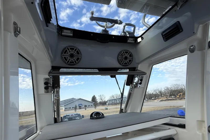 Slide: The Image of Interior view of 2023 Solace 30 HCS boat, featuring speakers and panoramic windows. - 26