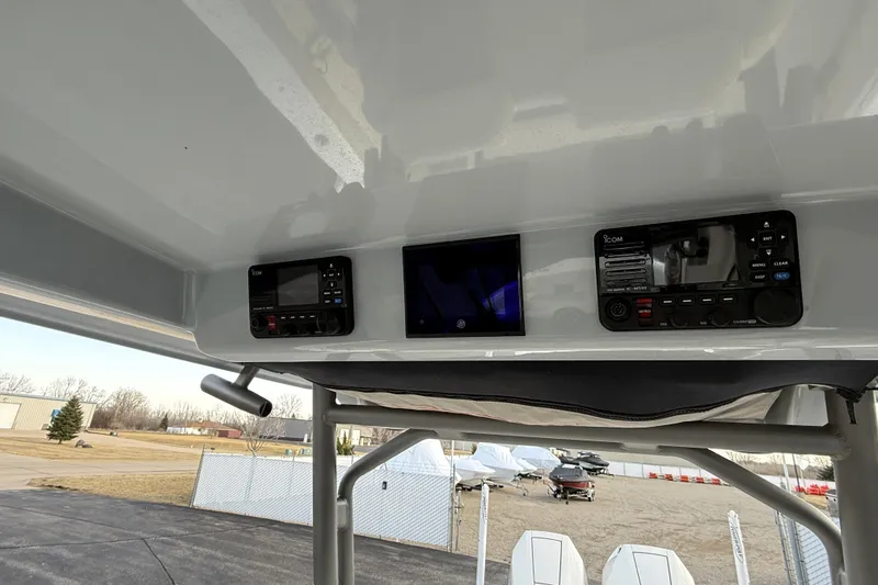 Slide: The Image of 2023 Solace 30 HCS boat dashboard with electronic controls and navigation display. - 27