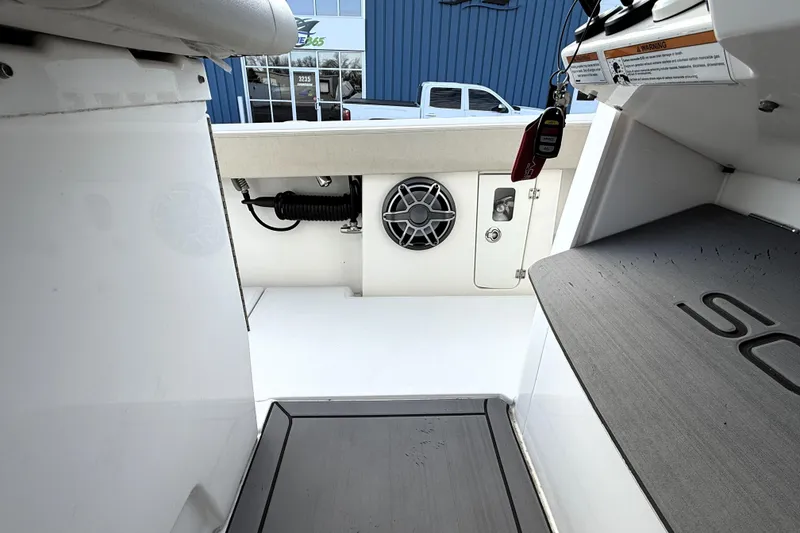 Slide: The Image of Interior view of 2023 Solace 30 HCS boat, featuring speaker and storage compartment. - 28