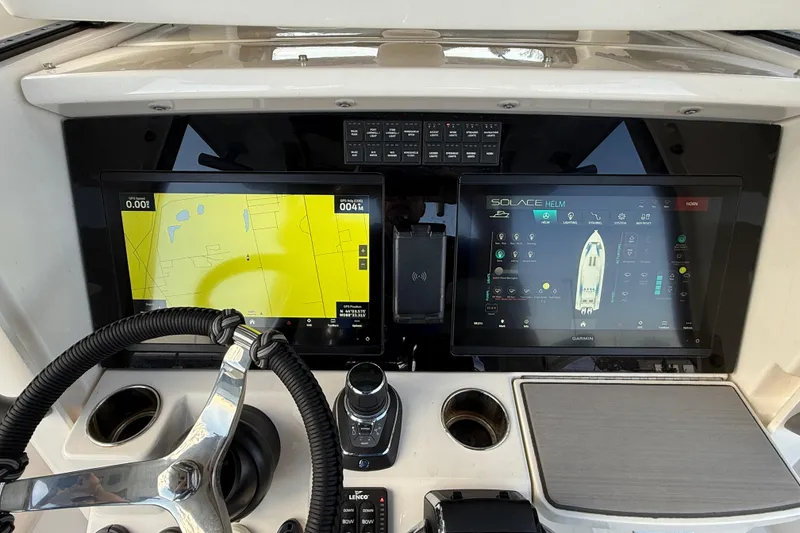 Slide: The Image of 2023 Solace 30 HCS helm with dual navigation screens and steering wheel. - 33