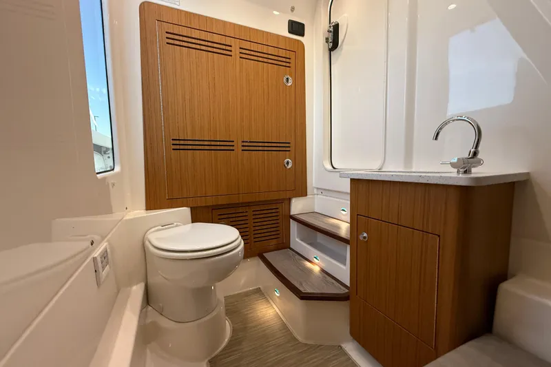 Slide: The Image of 2023 Solace 30 HCS boat interior with wooden cabinetry and modern fixtures. - 38