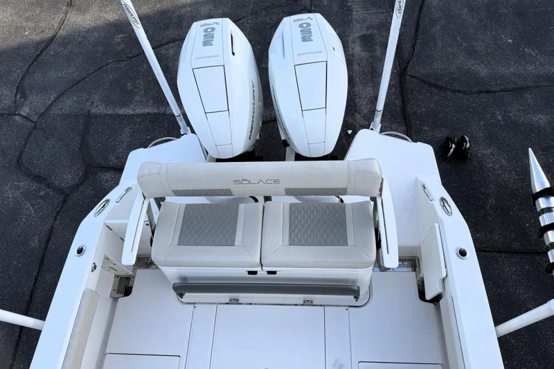 Slide: The Image of 2023 Solace 30 HCS boat with dual Mercury outboard engines, rear seating view. - 43