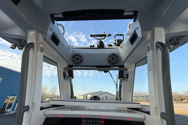 Slide: The Image of Interior view of 2023 Solace 30 HCS boat with open roof and speakers. - 44