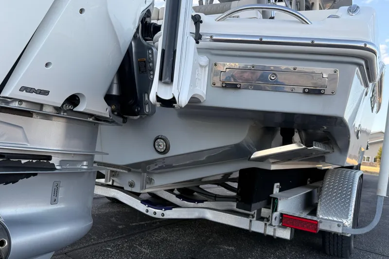 Slide: The Image of 2023 Solace 30 HCS boat on trailer, showcasing engine and hull details. - 46