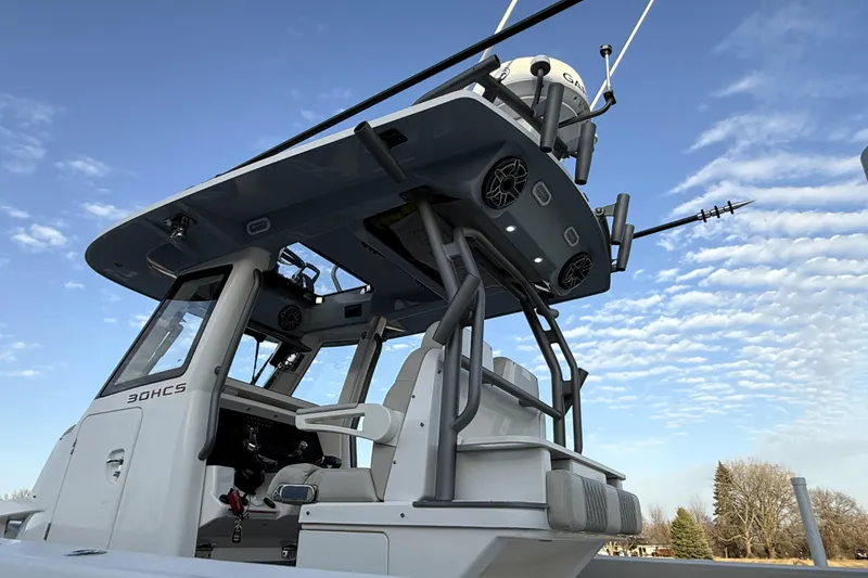 Slide: The Image of 2023 Solace 30 HCS boat with advanced navigation equipment against a blue sky. - 47