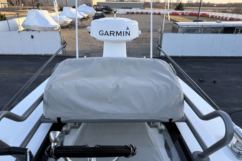 Slide: The Image of 2023 Solace 30 HCS boat with Garmin radar, docked in a marina. - 49
