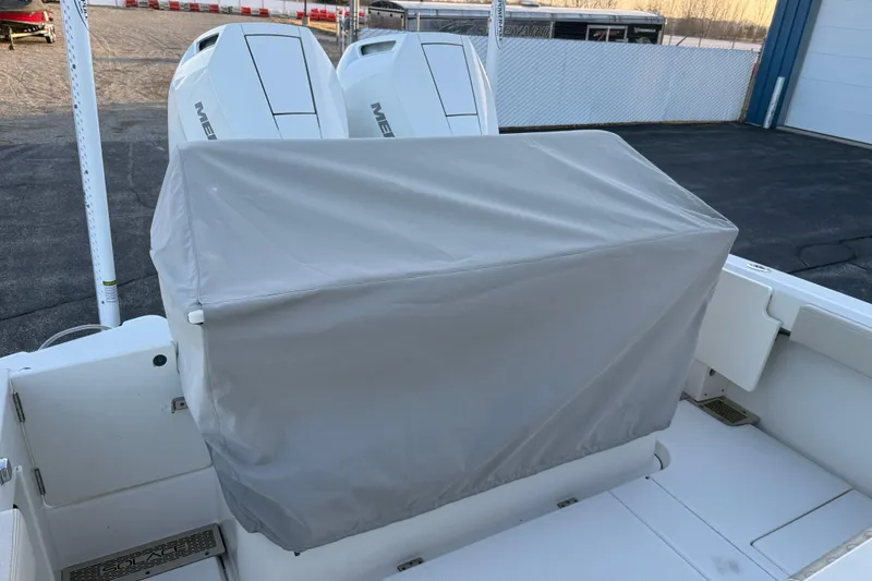 Slide: The Image of 2023 Solace 30 HCS boat with covered seating and dual Mercury engines. - 52