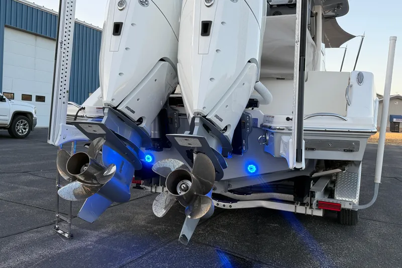 Slide: The Image of 2023 Solace 30 HCS boat with dual outboard engines and illuminated propellers. - 54