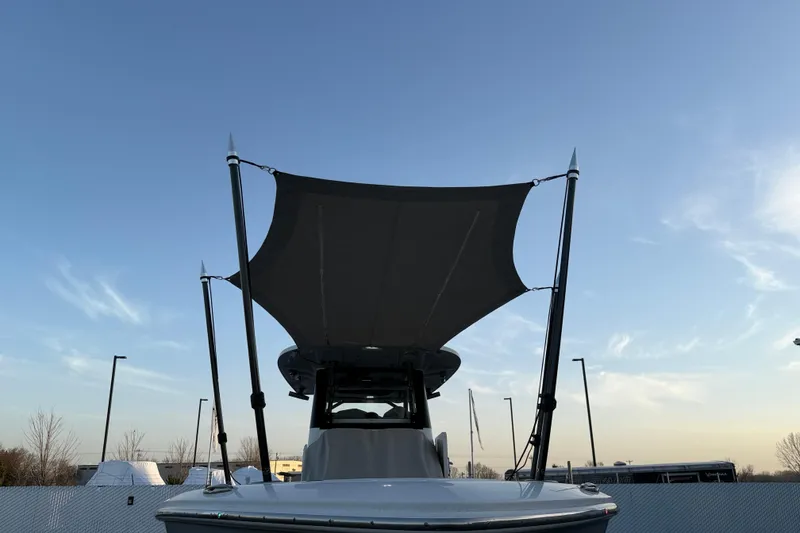 Slide: The Image of 2023 Solace 30 HCS boat with canopy against a clear sky. - 56