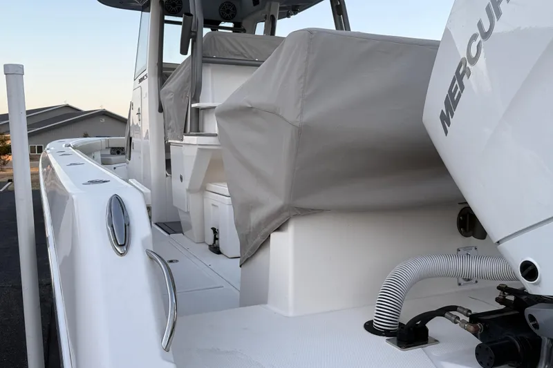 Slide: The Image of 2023 Solace 30 HCS boat with Mercury engine, covered seating, and sleek design. - 60