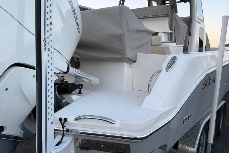 Slide: The Image of 2023 Solace 30 HCS boat with Mercury engine, rear view on trailer. - 61