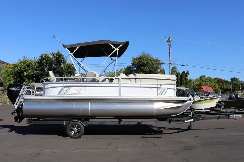 The Image of 2023 SunChaser Vista 20 Fish pontoon boat on trailer, parked outdoors. - 1