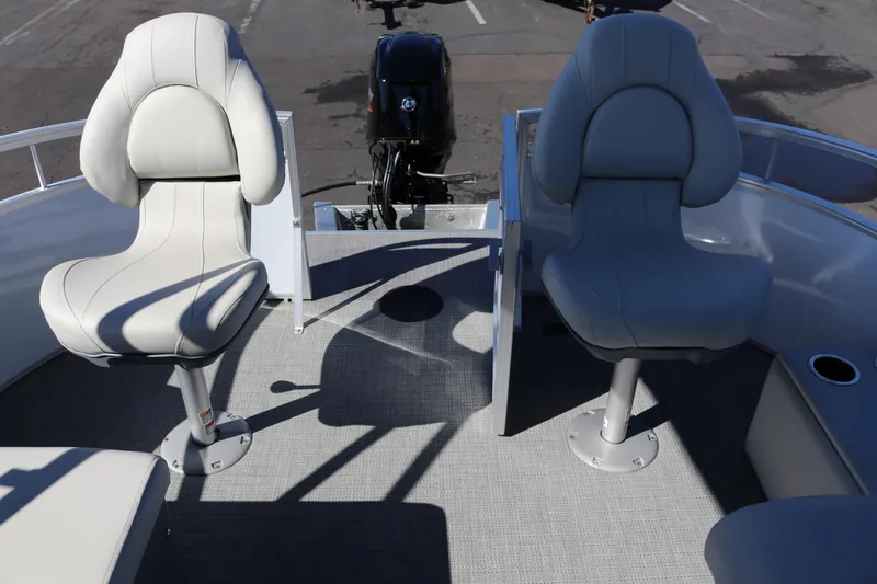 Slide: The Image of 2023 SunChaser Vista 20 Fish boat interior with two swivel seats and motor. - 12