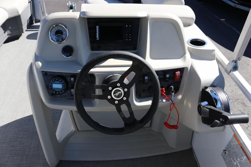 Slide: The Image of 2023 SunChaser Vista 20 Fish boat dashboard with steering wheel and controls. - 14