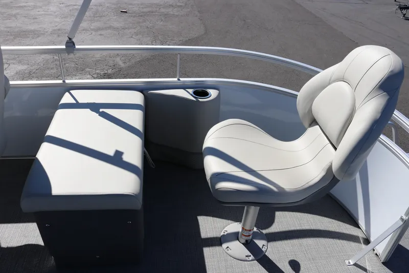 Slide: The Image of 2023 SunChaser Vista 20 Fish boat interior with cushioned seating and cup holder. - 20