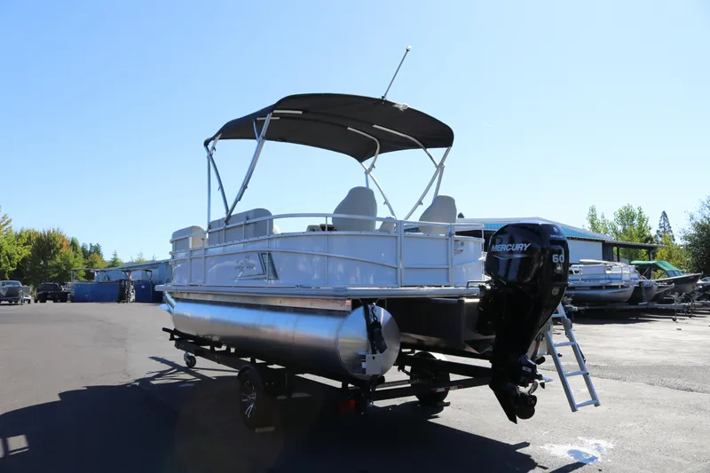 Slide: The Image of 2023 SunChaser Vista 20 Fish pontoon boat with Mercury 60 engine, parked outdoors. - 3