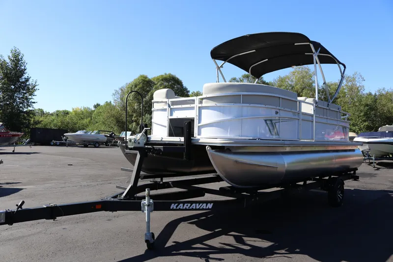 Slide: The Image of 2023 SunChaser Vista 20 Fish pontoon boat on Karavan trailer, parked outdoors. - 5