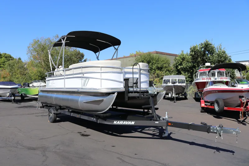 Slide: The Image of 2023 SunChaser Vista 20 Fish pontoon boat on trailer in outdoor lot. - 7