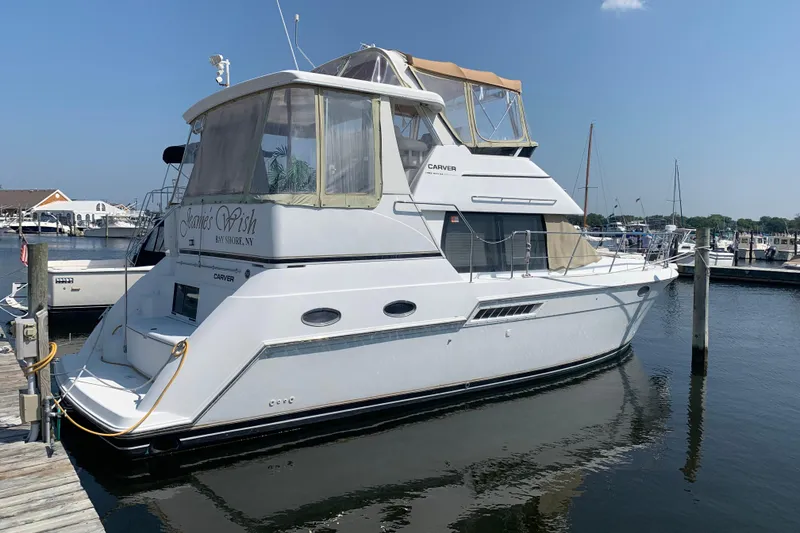 Slide: The Image of 2000 Carver 356 Aft Cabin Motor Yacht docked at marina under clear sky. - 12