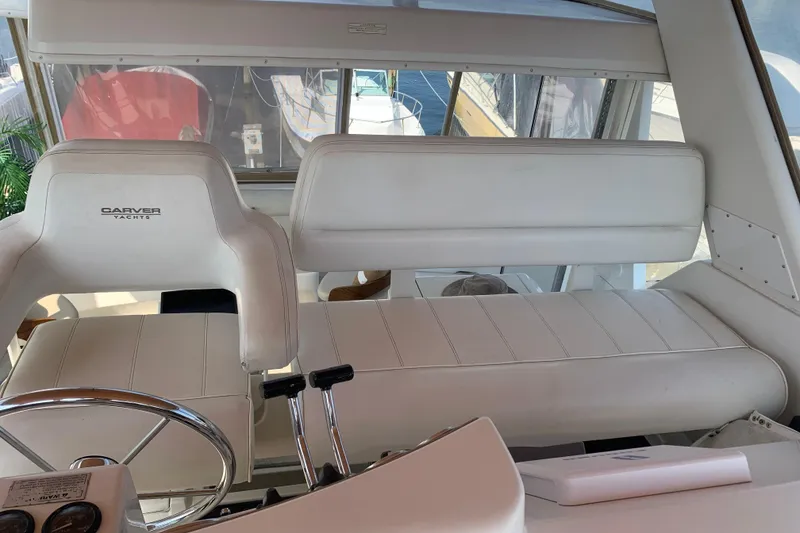Slide: The Image of Interior of 2000 Carver 356 Aft Cabin Motor Yacht with white seating and steering wheel. - 16