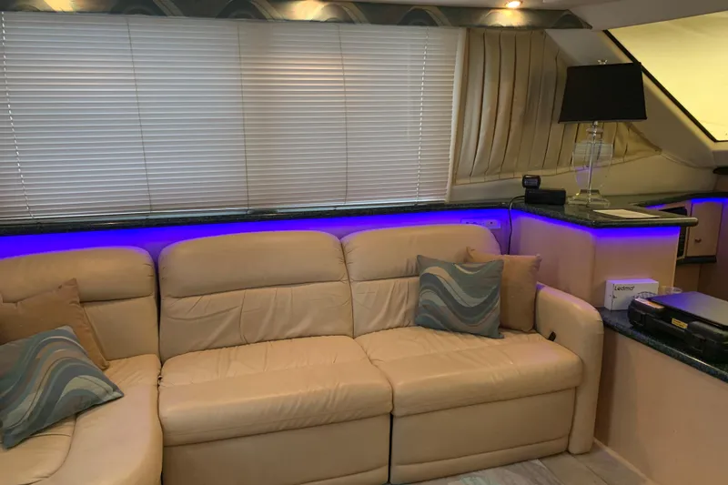 Slide: The Image of Interior of 2000 Carver 356 Aft Cabin Motor Yacht with beige sofa and ambient lighting. - 22
