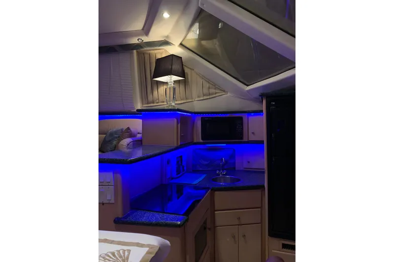 Slide: The Image of Interior of 2000 Carver 356 Aft Cabin Motor Yacht with modern kitchen lighting. - 23