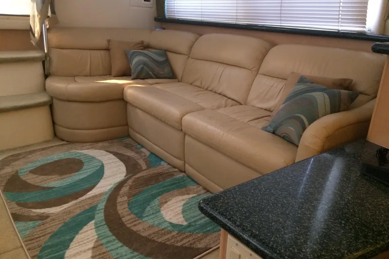 Slide: The Image of Interior of 2000 Carver 356 Aft Cabin Motor Yacht with beige leather seating and patterned rug. - 26