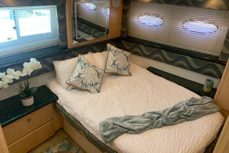 Slide: The Image of Cozy bedroom in 2000 Carver 356 Aft Cabin Motor Yacht with decorative pillows and flowers. - 28