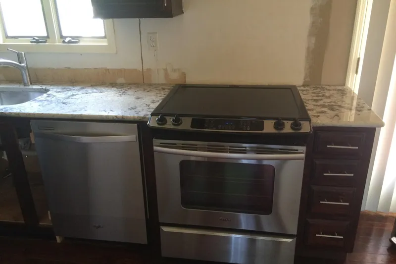 Slide: The Image of Modern kitchen with stainless steel appliances and marble countertops. - 29