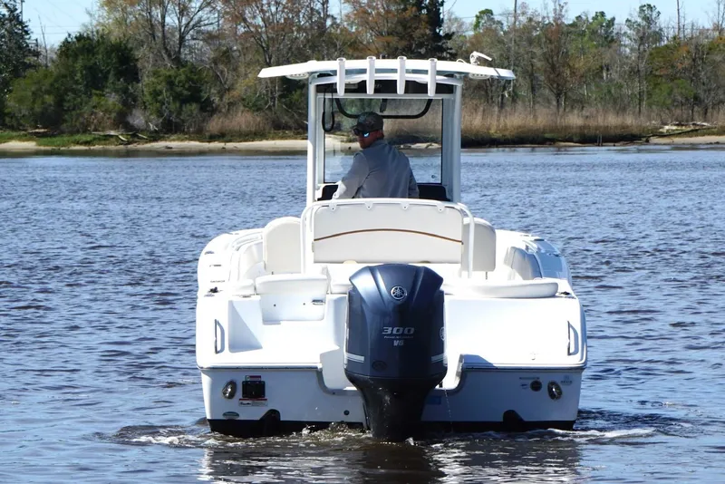 Slide: The Image of 2021 Sea Hunt Ultra 255 SE boat cruising on a calm lake. - 4