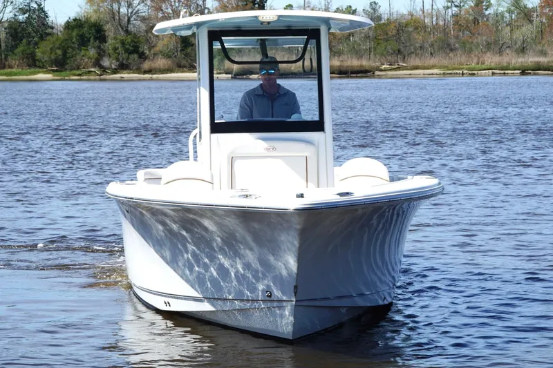 Slide: The Image of 2021 Sea Hunt Ultra 255 SE boat cruising on a calm lake. - 5