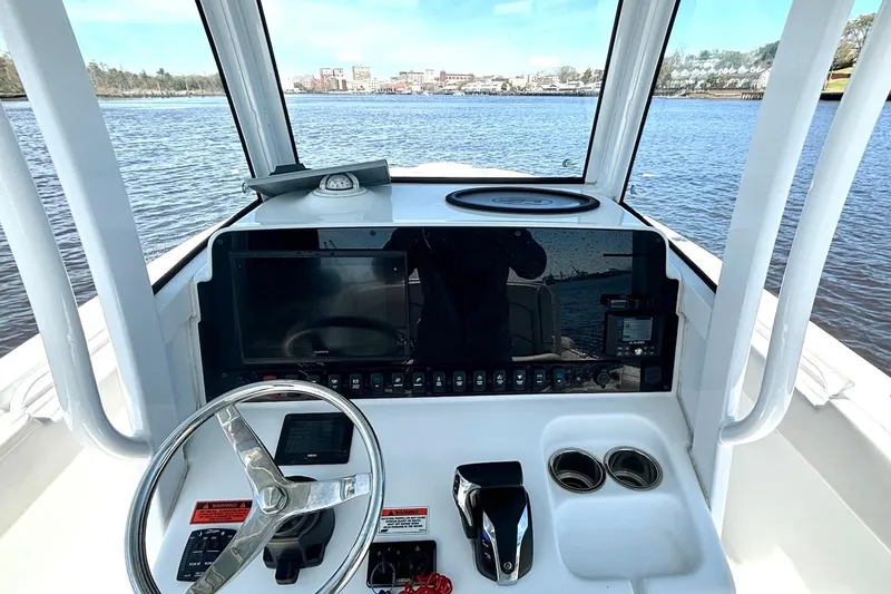 Slide: The Image of Cockpit view of 2021 Sea Hunt Ultra 255 SE boat on water. - 7