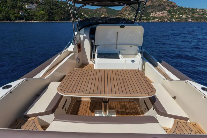 Slide: The Image of Manufacturer Provided Image: 2025 Nuova Jolly Prince 38 Sport Cabin with teak deck, on serene blue water. - 2