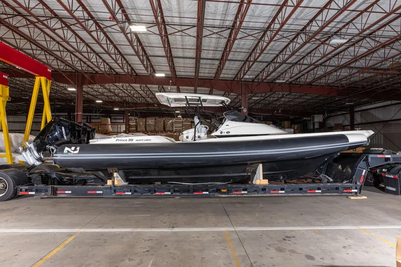 Slide: The Image of 2025 Nuova Jolly Prince 38 Sport Cabin boat in warehouse on trailer. - 4