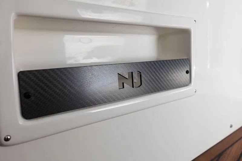 Slide: The Image of Nuova Jolly Prince 38 Sport Cabin 2025 logo on sleek carbon fiber panel. - 8
