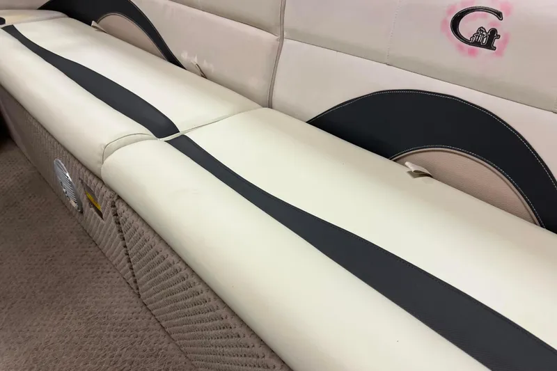 Slide: The Image of 2014 Avalon Grand Island 2485 QF boat interior with beige and black seating. - 16