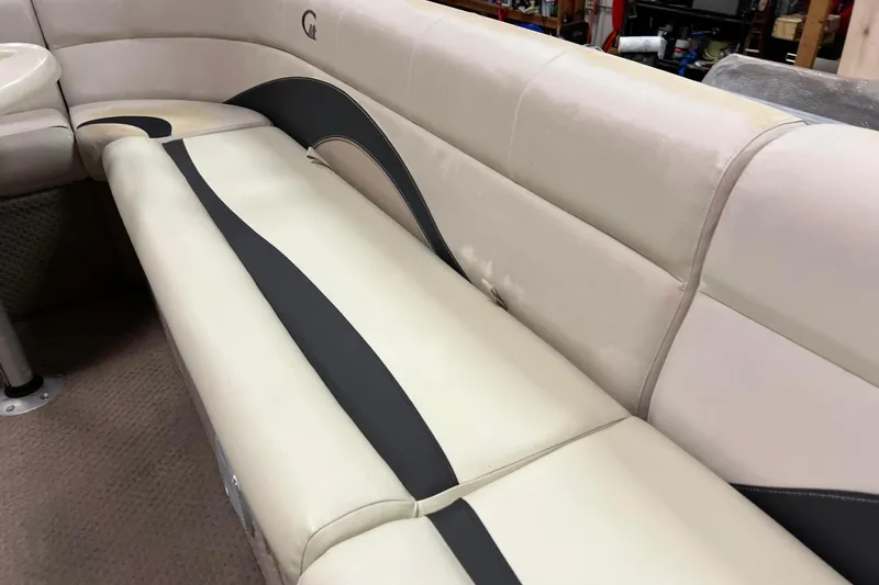 Slide: The Image of 2014 Avalon Grand Island 2485 QF boat interior with beige and black seating. - 17