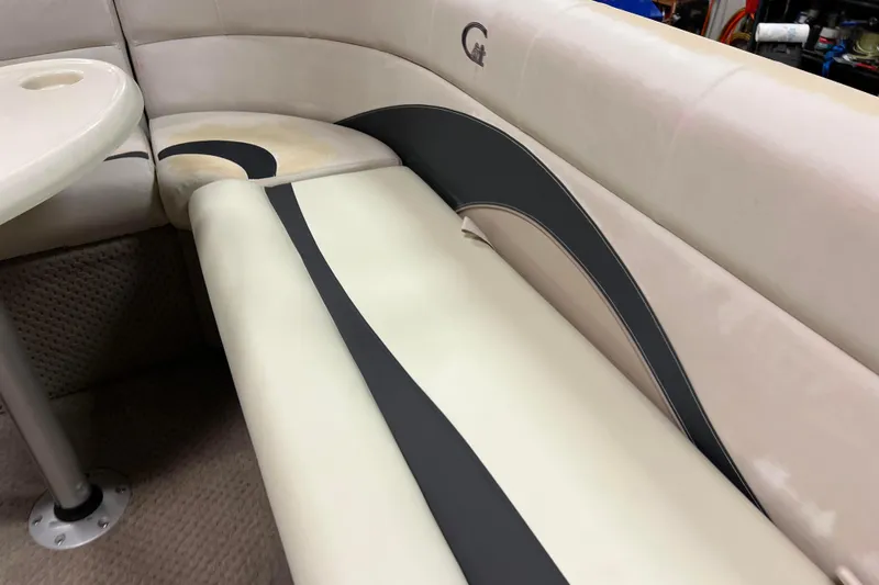 Slide: The Image of 2014 Avalon Grand Island 2485 QF boat interior with beige and black seating. - 18