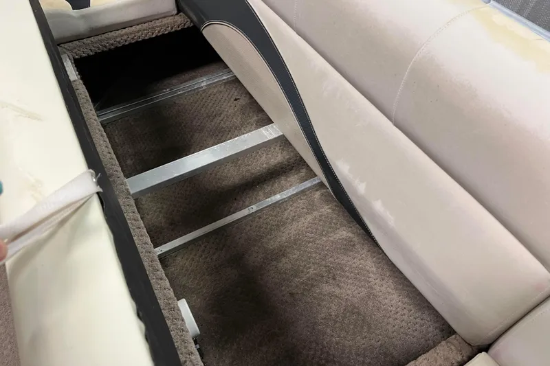 Slide: The Image of 2014 Avalon Grand Island 2485 QF boat interior storage compartment with beige seating. - 22