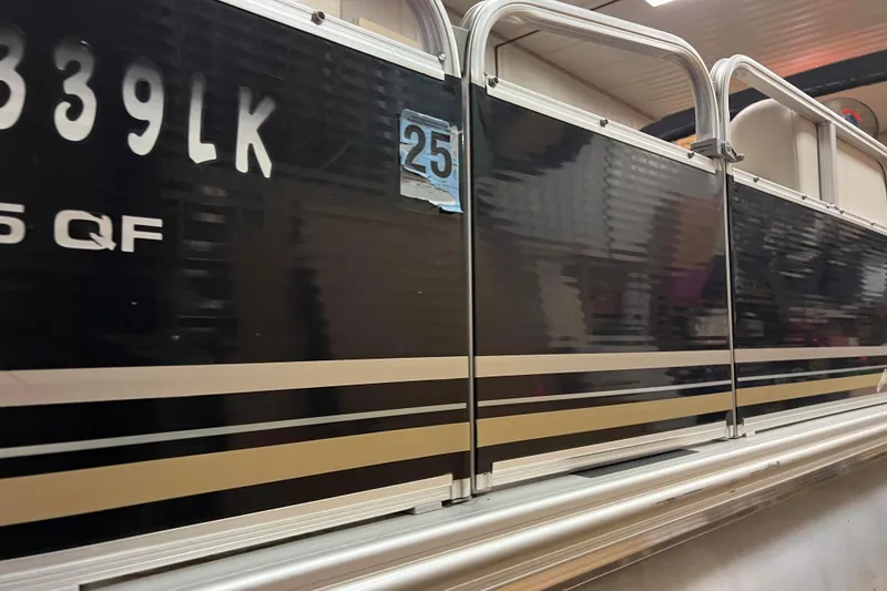 Slide: The Image of 2014 Avalon Grand Island 2485 QF pontoon boat with black and gold exterior. - 33